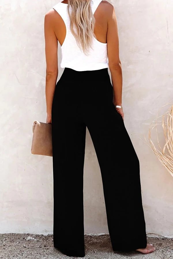 Close-up of smocked elastic waistband on high-waisted trousers in a soft breathable fabric