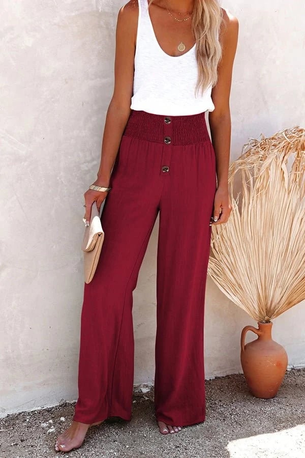 Woman in white high-waisted trousers paired with a fitted blouse for a polished outfit