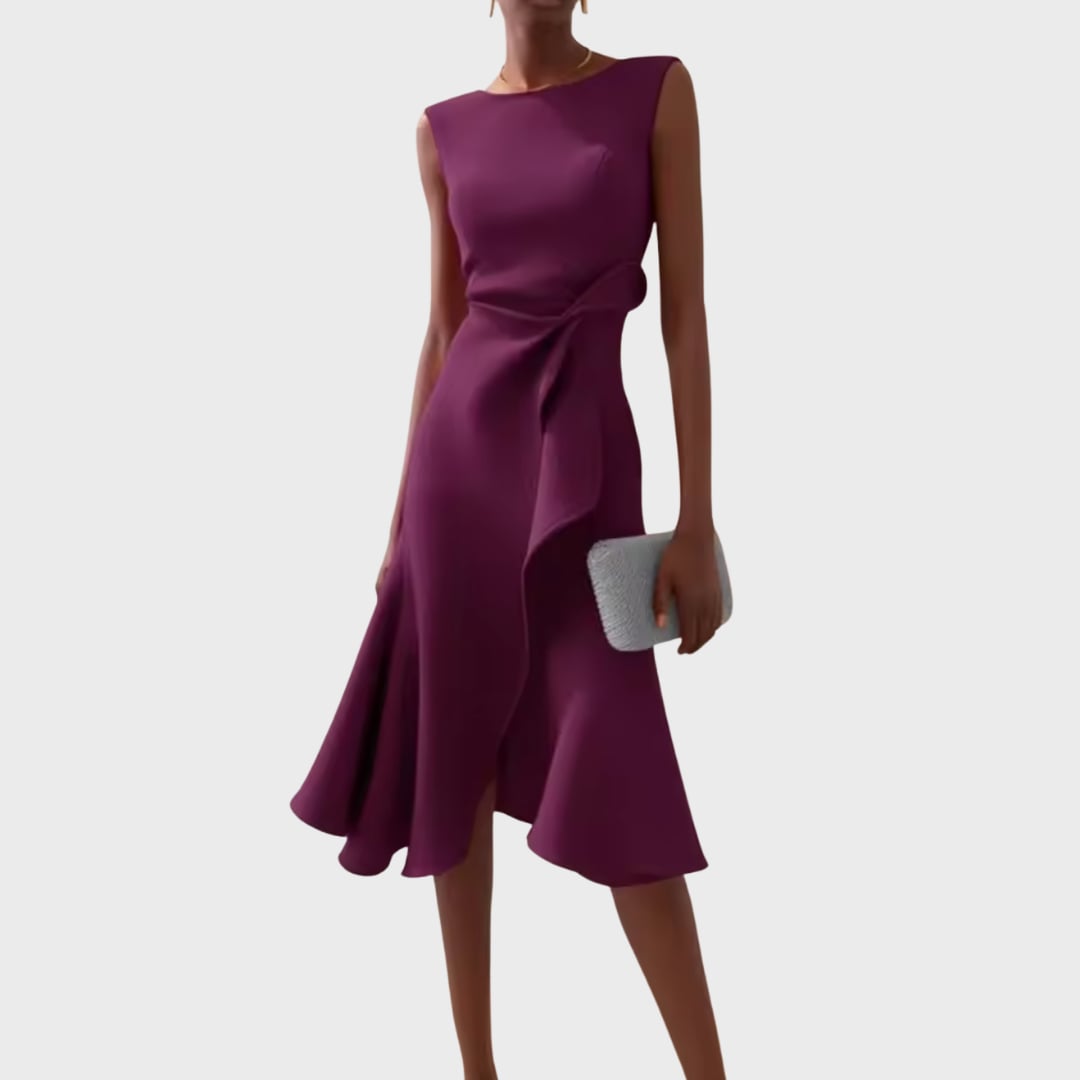 Model posing in the draped asymmetric midi dress at a styled event setting
