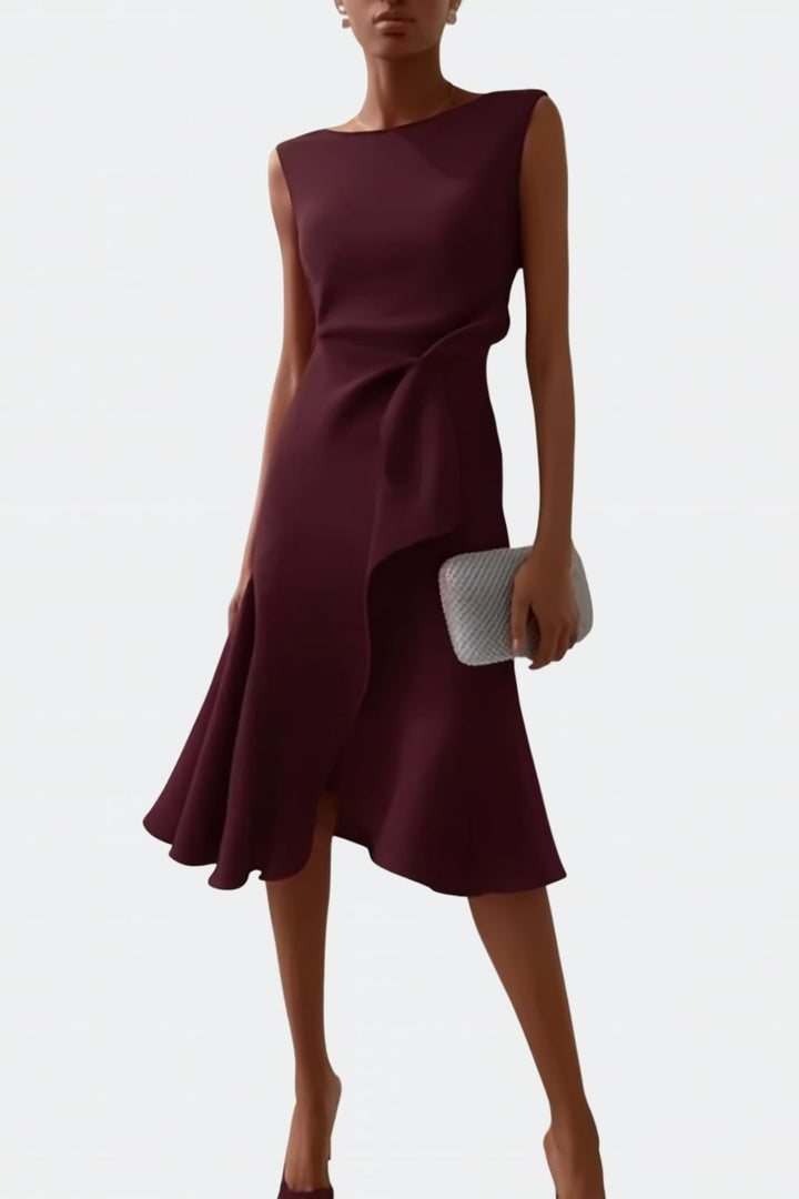 Draped asymmetric midi dress styled with heeled sandals for a wedding guest look