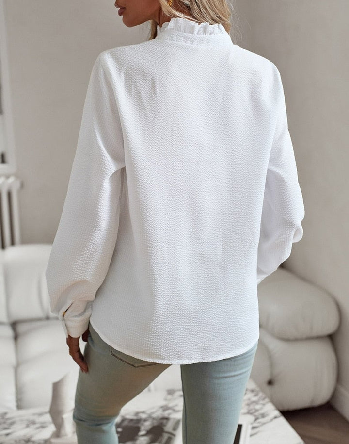 Side profile of the Sheri blouse showing the relaxed drape and elegant feminine fit