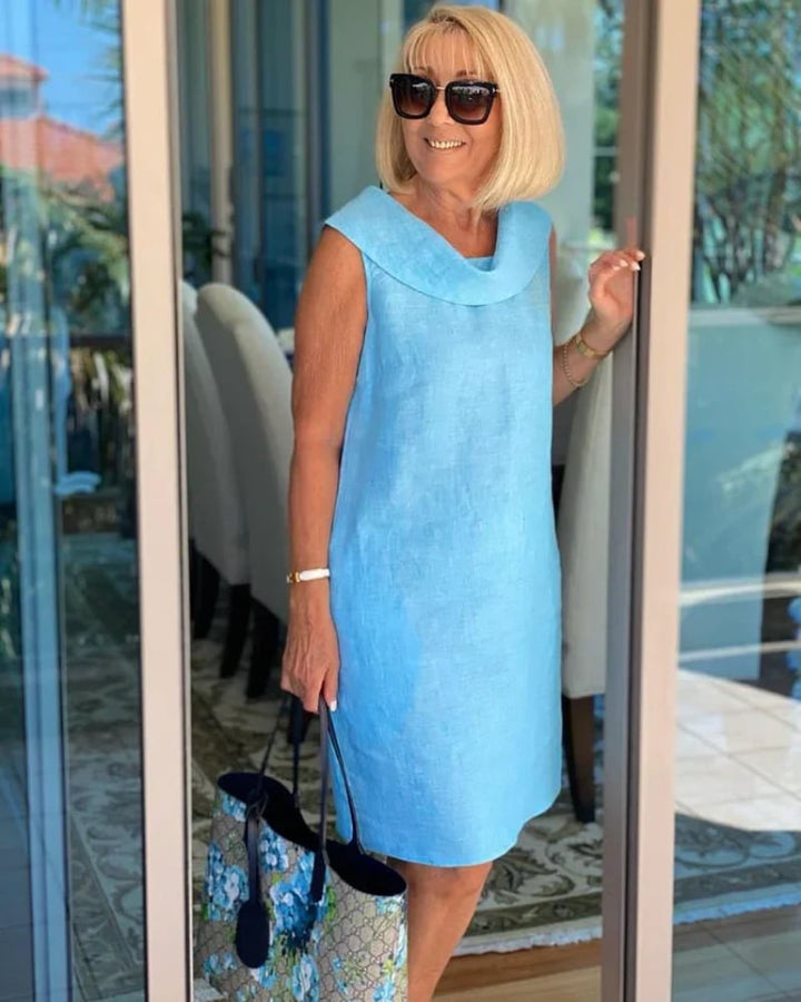 Front view of a breezy sleeveless dress with a softly structured neckline shown in sky blue