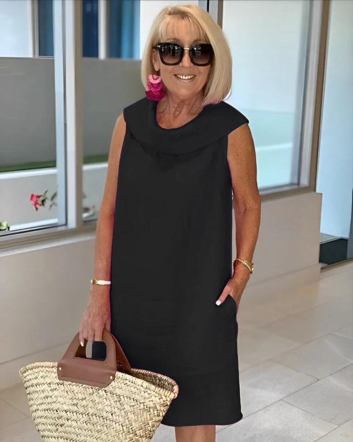 Model posing in a lightweight sleeveless summer dress highlighting the relaxed fit and flattering silhouette