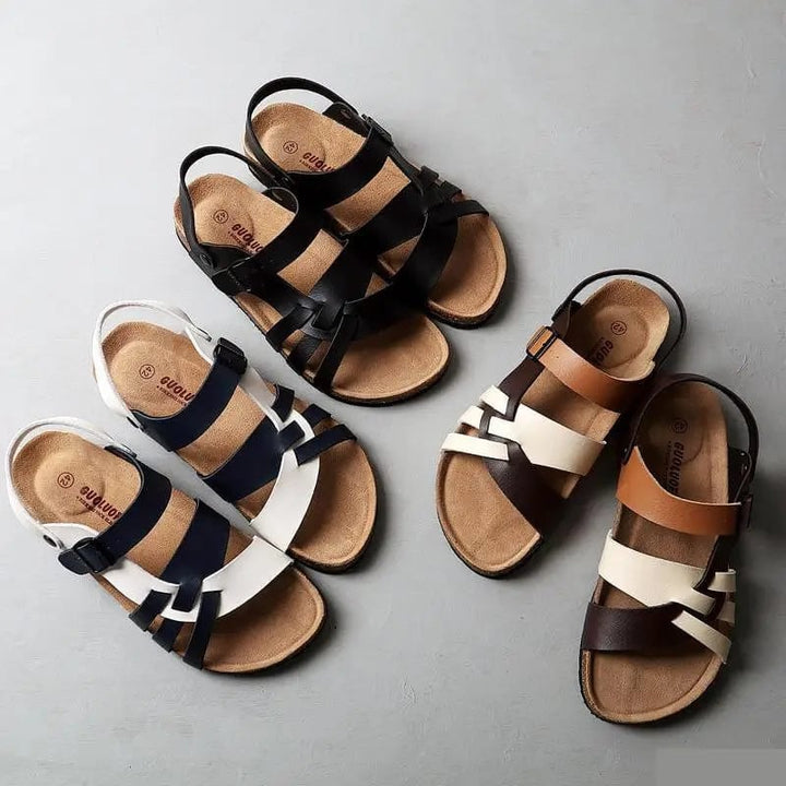 Model wearing Sienna women's sandals in brown paired with a flowy sundress outdoors