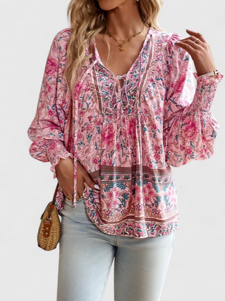 Front view of the Sienna floral boho blouse in pink with puff sleeves and V-neck tie closure