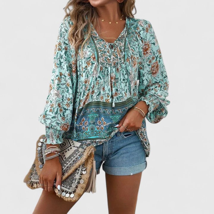 Side view of the Sienna floral boho blouse showing the relaxed smocked bodice and ruffle cuffs