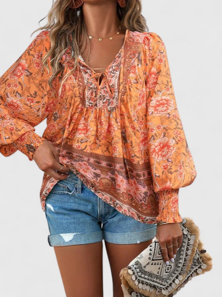 Close-up of the ruffle cuff detail on the Sienna floral boho blouse in navy blue