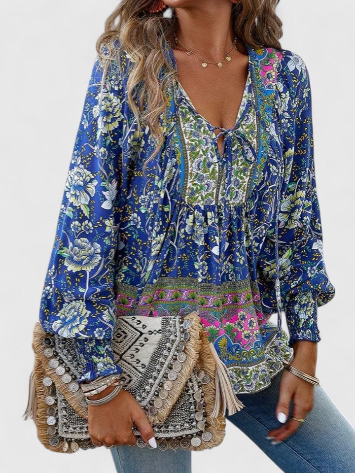 Model wearing the Sienna floral boho blouse in orange styled with a flowy midi skirt