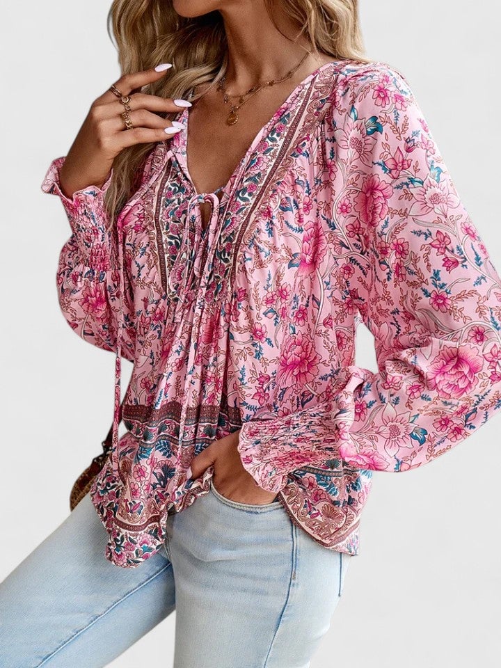 Flat lay of the Sienna floral boho blouse in orange showing the all-over floral print