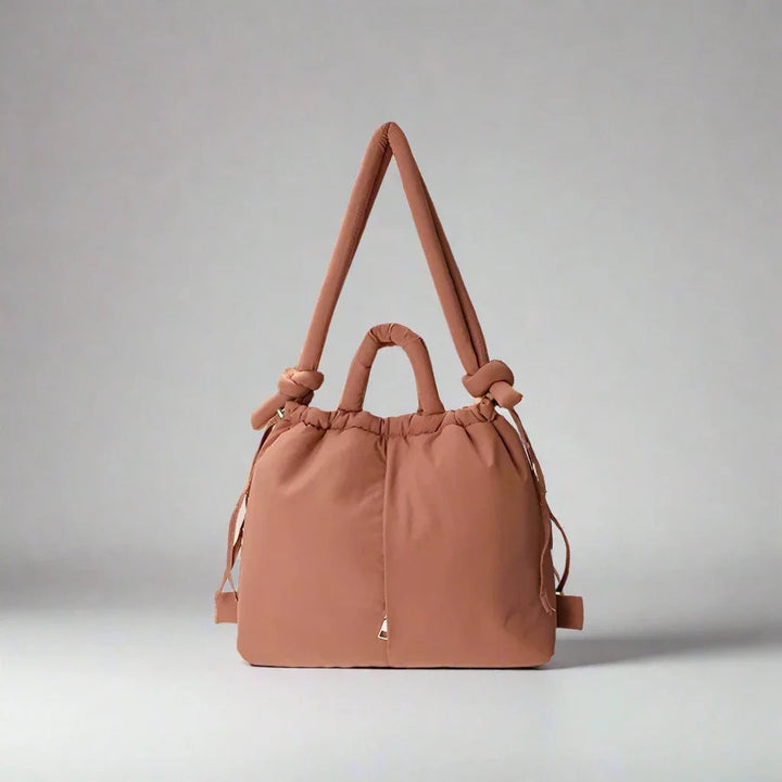 Sienna quilted puffer tote bag being carried over the shoulder by a woman