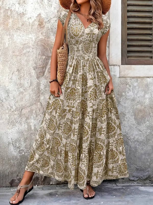 Woman wearing the Sienna smocked boho tiered maxi dress in khaki with a damask-inspired print and cap sleeves