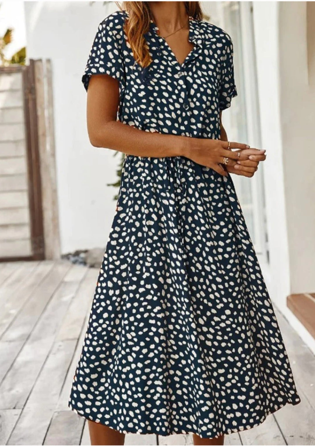 Close-up of adjustable drawstring waist tie on spotted print midi dress in green