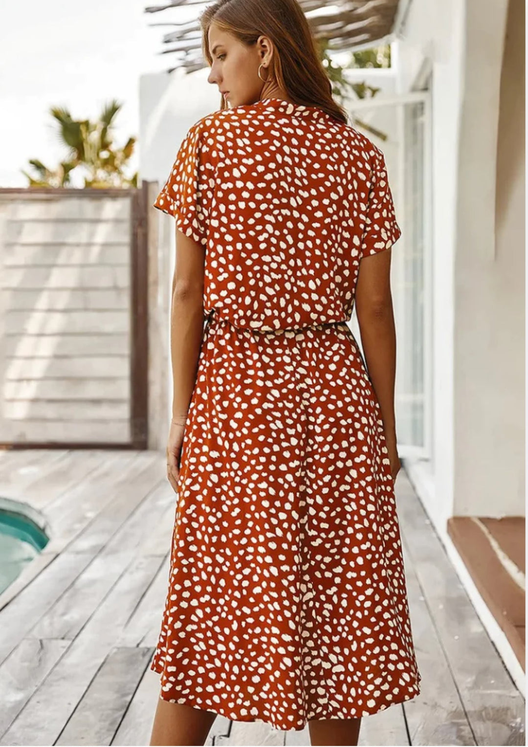 Women's spotted print midi dress in navy blue with drawstring waist, front view on model