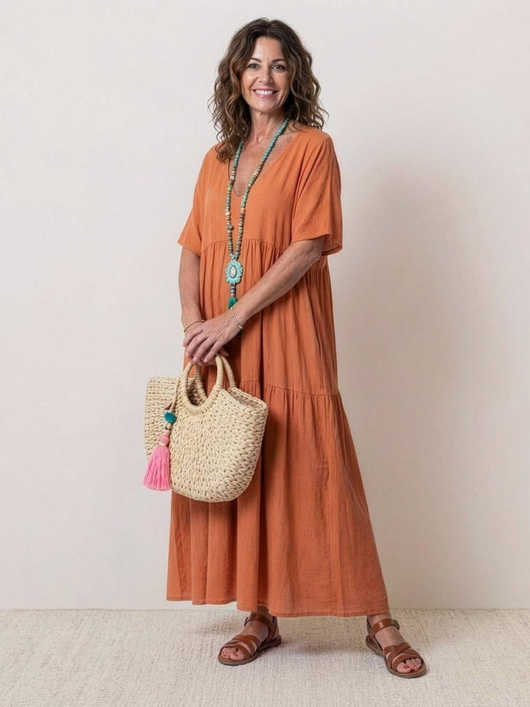 Front view of Sienna V-neck tiered maxi swing dress in rusty orange with short sleeves and floor-length two-tier skirt
