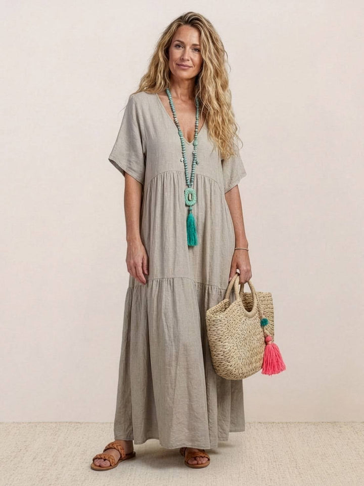 Close-up of deep V-neckline detail on Sienna tiered maxi dress in rusty orange