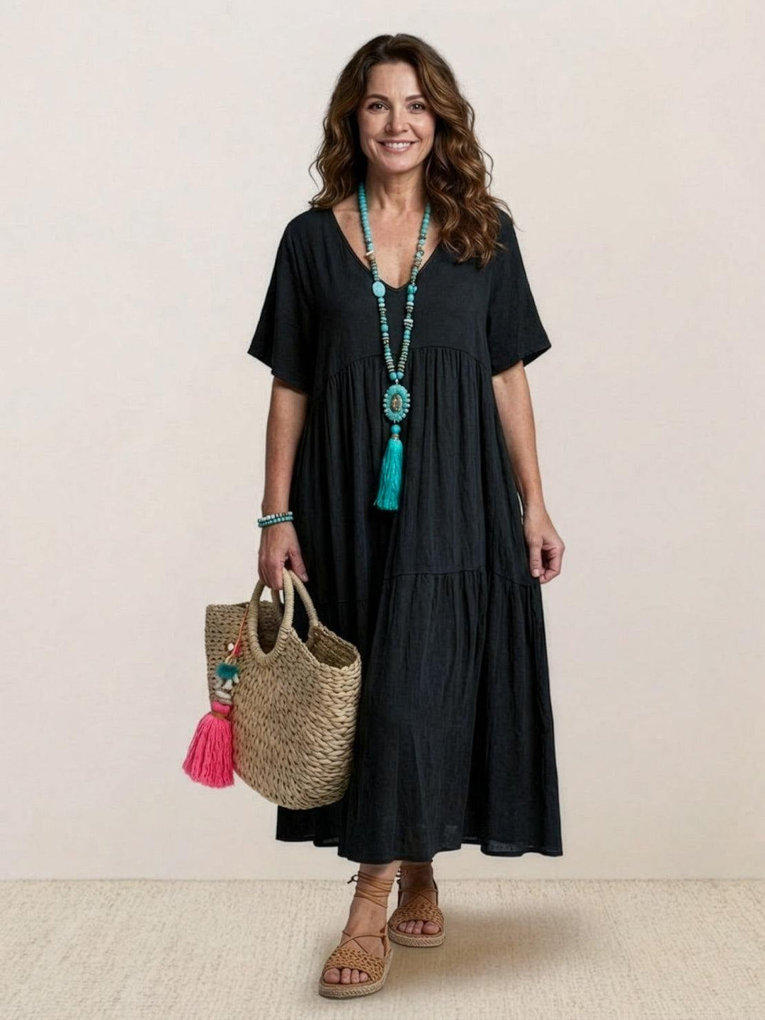 Side view of Sienna maxi dress in rusty orange highlighting two-tiered skirt construction