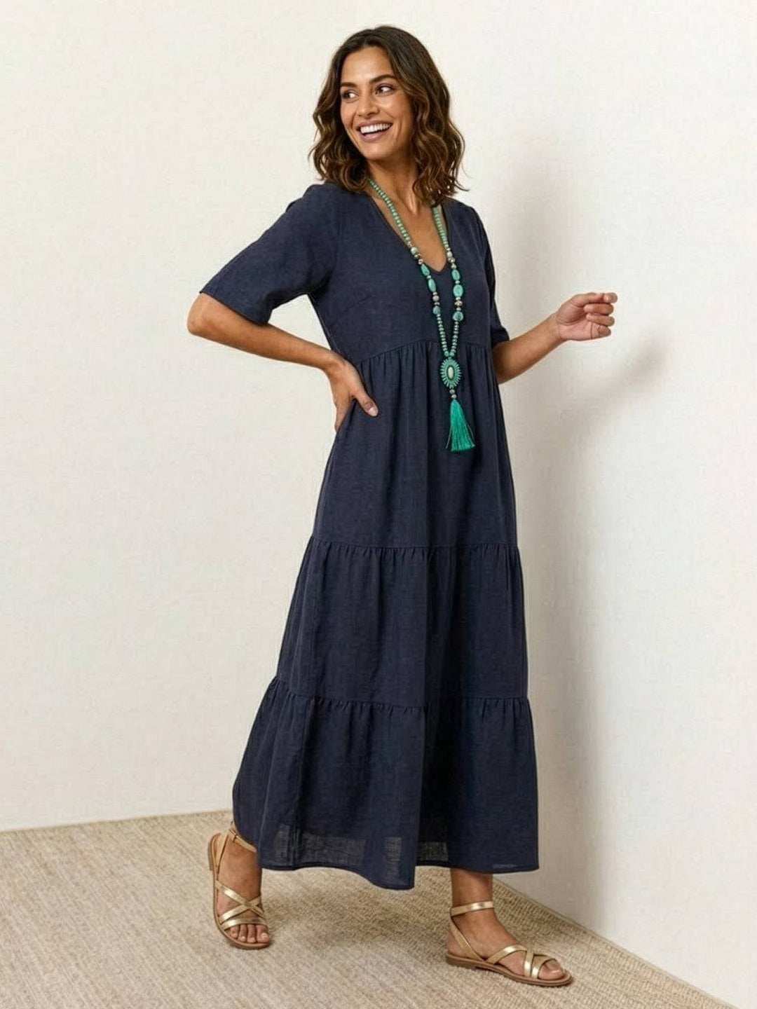 Full-length lifestyle shot of Sienna swing maxi dress in rusty orange worn with flat sandals