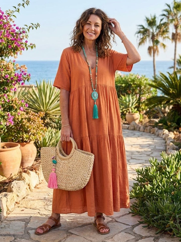 Lifestyle image of Sienna tiered maxi dress in army green styled casually outdoors