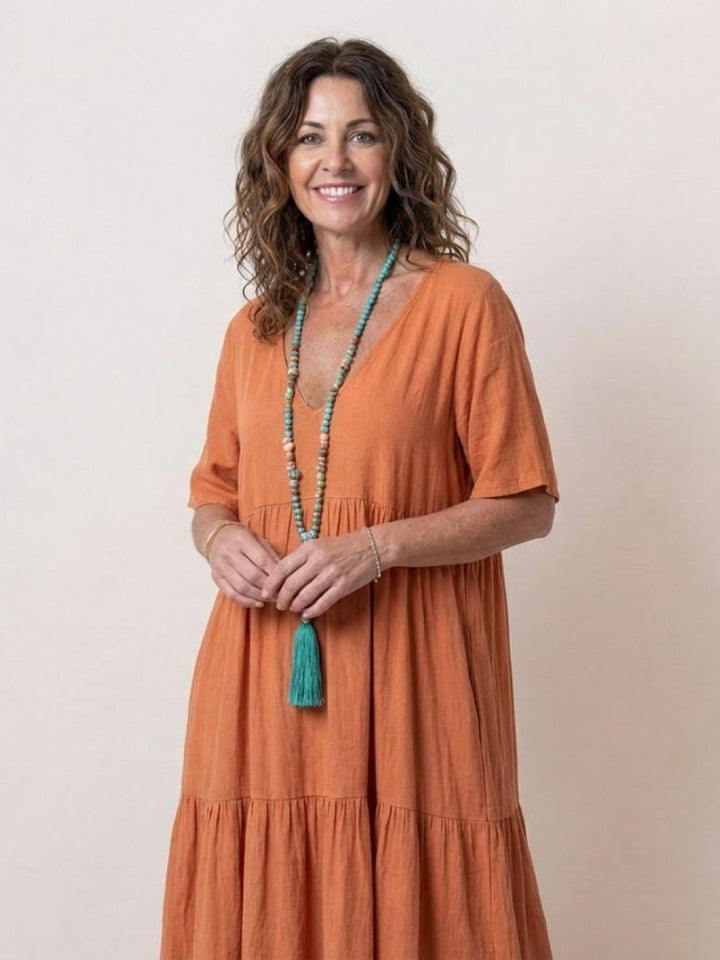 Back view of Sienna tiered maxi dress in apricot showing full-length silhouette