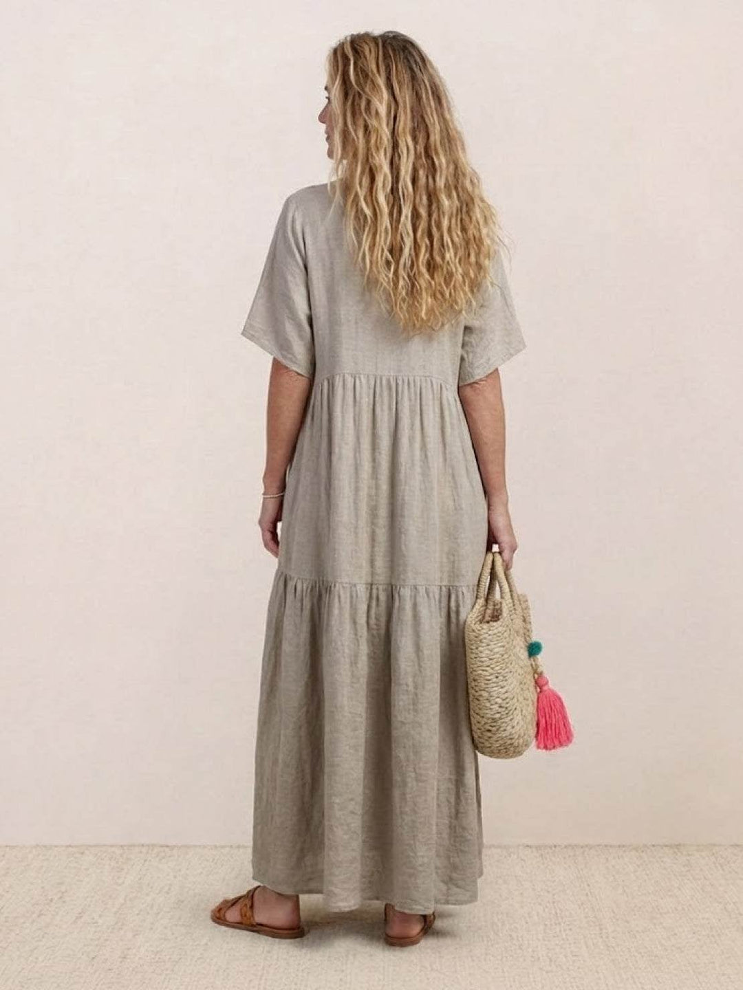 Side view of Sienna V-neck maxi dress in black showing floor-length cut