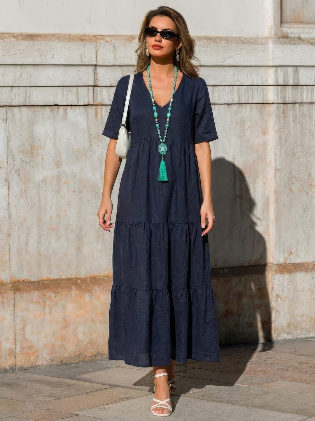 Full-length lifestyle shot of Sienna swing dress in navy blue worn outdoors