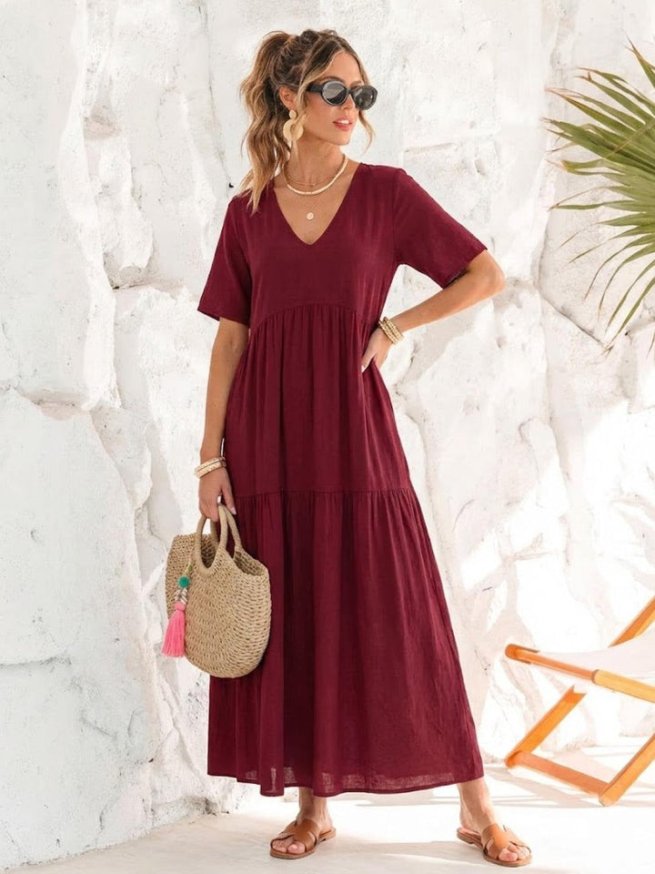 Side view of Sienna swing maxi dress in red highlighting floor-length hem