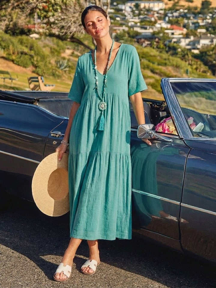 Close-up of V-neckline detail on Sienna maxi dress in peacock blue