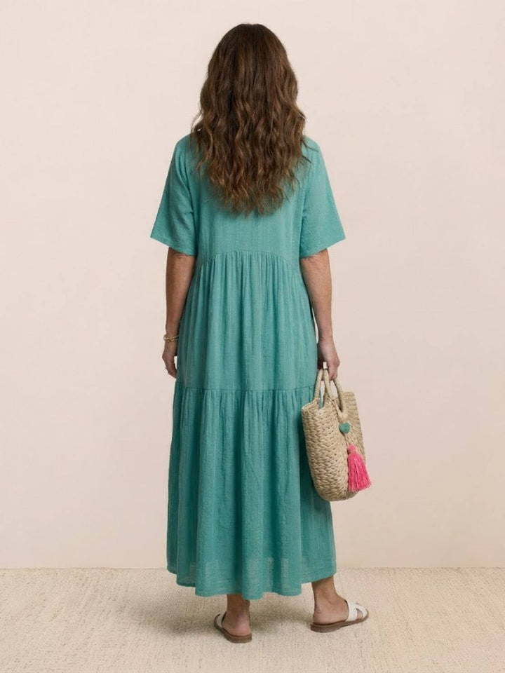 Lifestyle photo of Sienna maxi swing dress in peacock blue worn casually