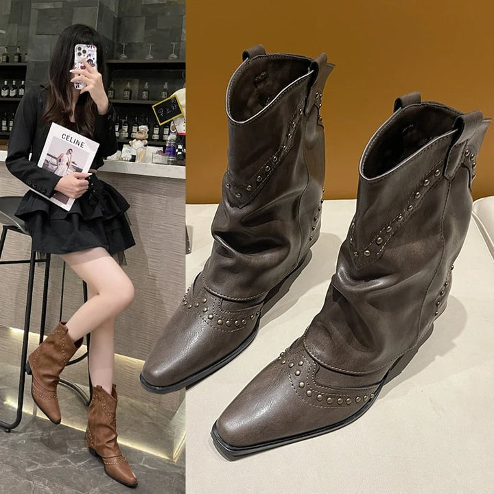 Close-up of metallic stud detailing on black western boots