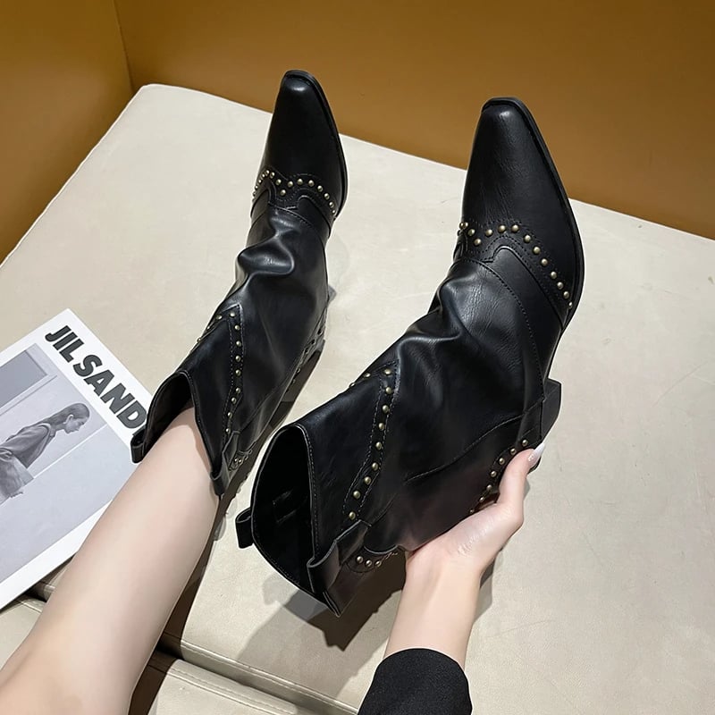 Pair of black Sierra western boots displayed flat lay on white background