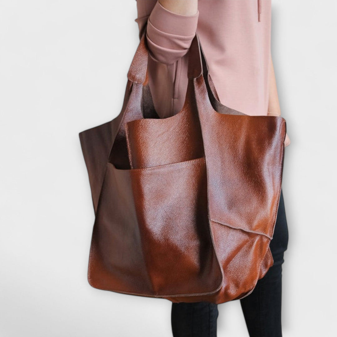 Overhead flat lay of the Sigrid Everyday Bag in black on a neutral surface