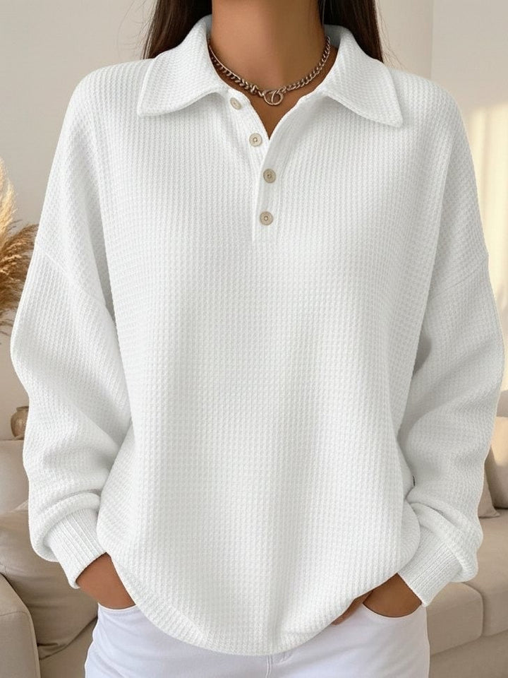 Close-up of the textured knit pattern and polo collar detail on the Sky polo sweater in red