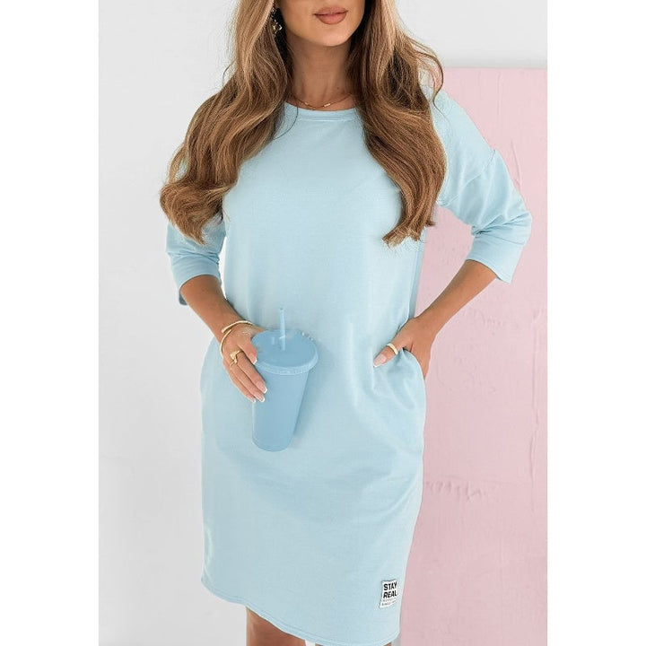 Close-up of the side stripe and hem detail on the blue Skye sweatshirt mini dress