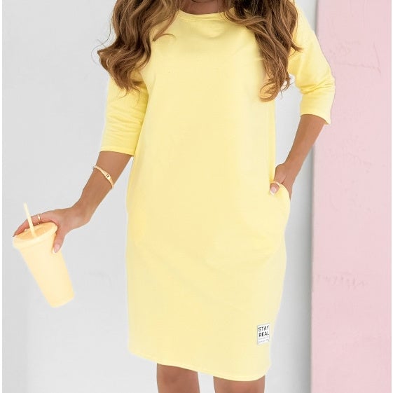 Side view of the yellow Skye sweatshirt dress showing sporty stripe detail and mini length