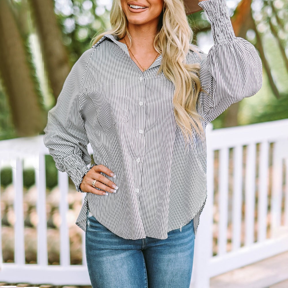 Woman wearing the Skye striped shirt belted at the waist, styled as a dress over neutral tones
