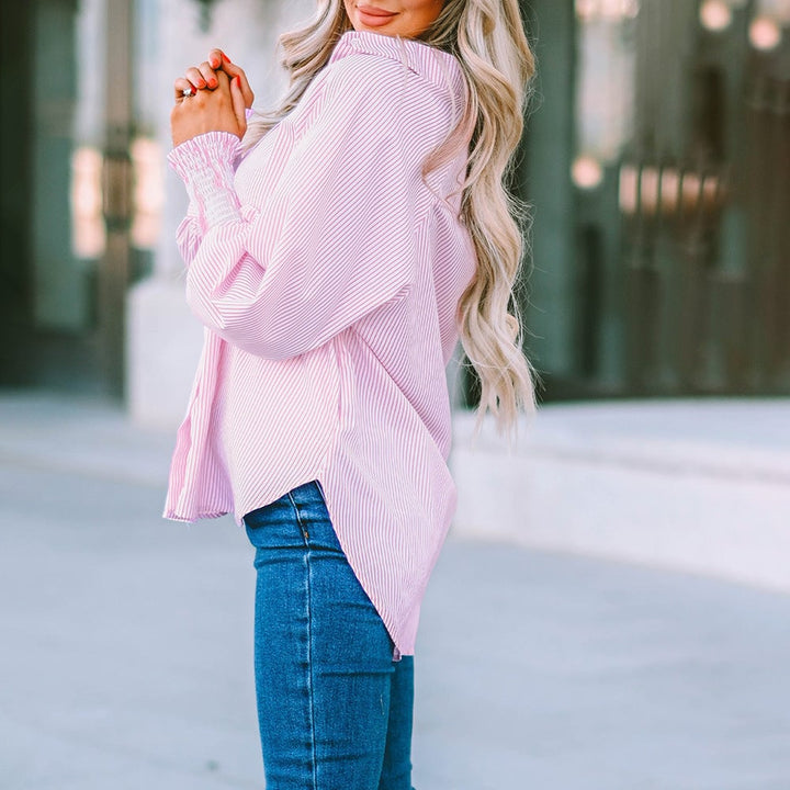 Skye striped oversized shirt worn open as a layer over a white cami and white jeans