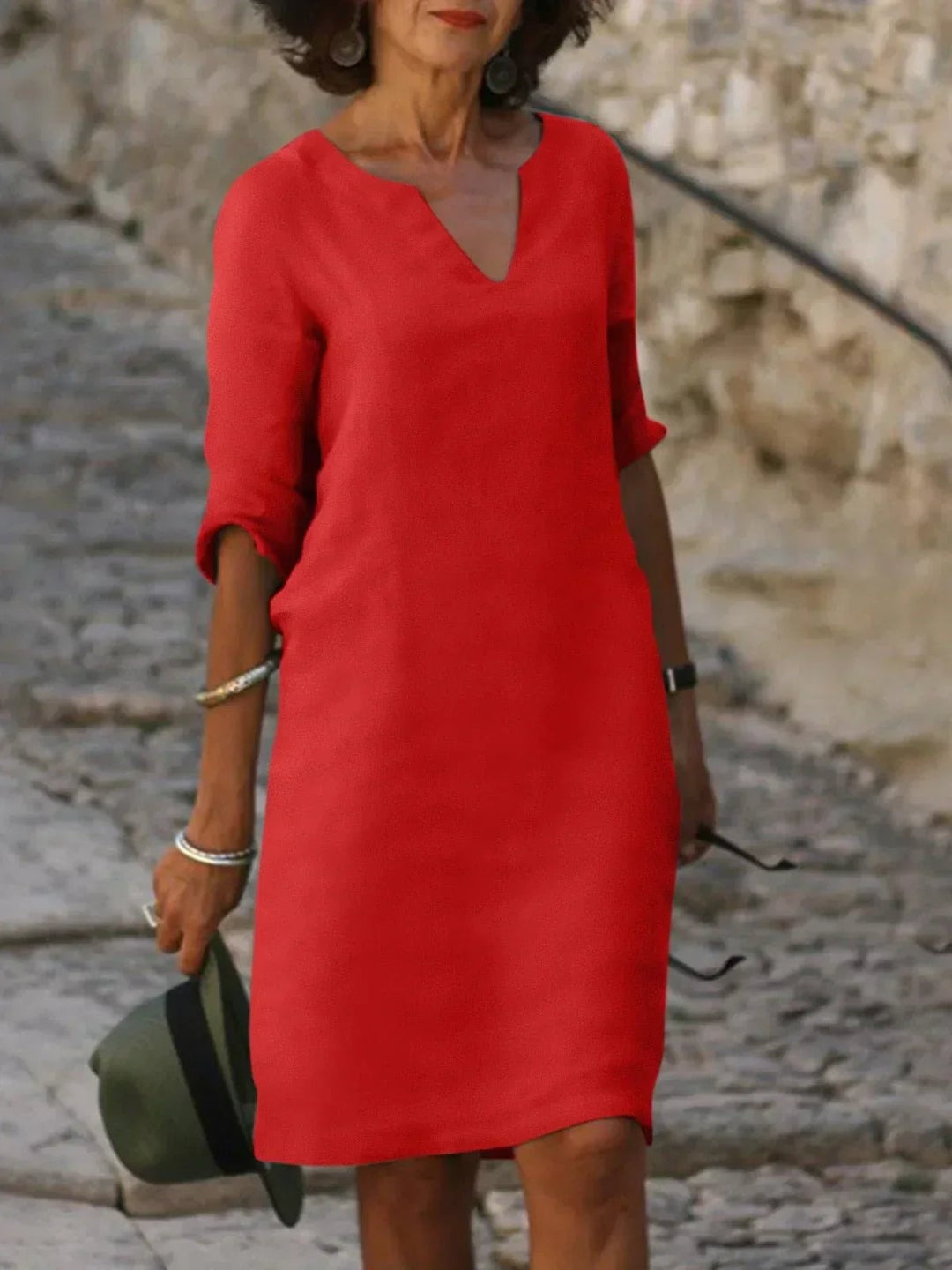 Woman wearing a white V-neck dress with flattering coverage styled for a special occasion