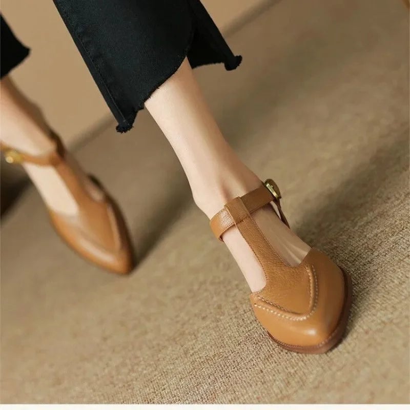 Sloane T-strap buckle flat in light brown with pointed toe and gold-tone buckle, front view