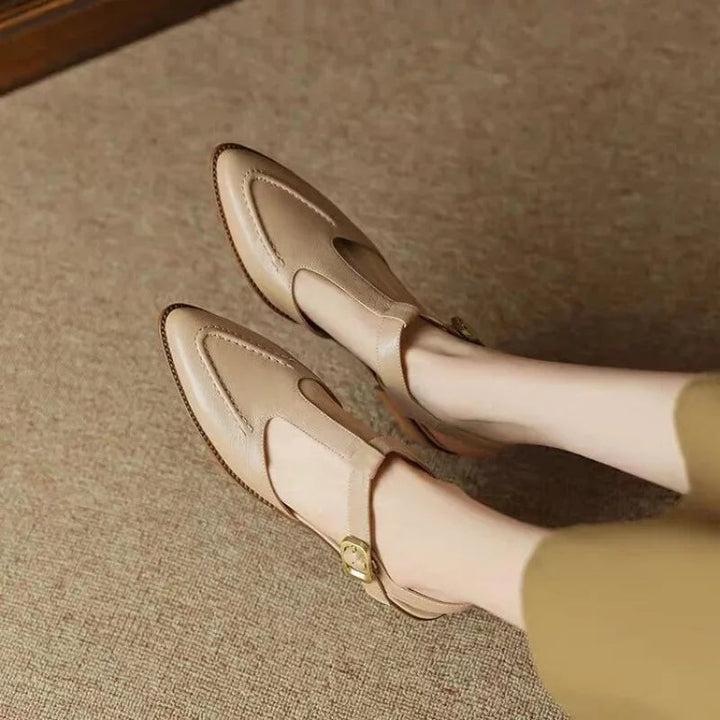 Overhead flat lay of both Sloane T-strap colorways — light brown and apricot — side by side