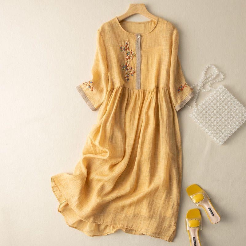 Full-length view of a flowy patterned midi dress with gathered waist showing ease of movement in a white colorway