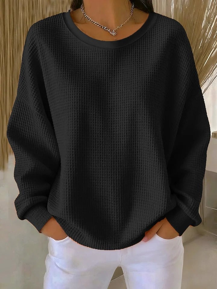 Full-length view of the Sofia textured knit sweater in black styled with tailored trousers for an elevated casual outfit