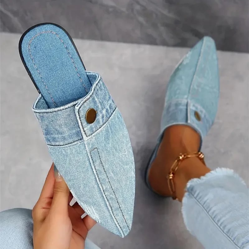 Sofia pointed toe denim mule flat in blue with gold-tone button accent, front three-quarter view
