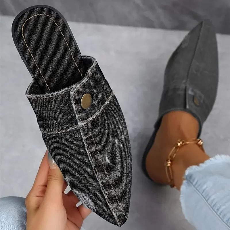 Sofia denim mule flat in black showing structured upper with stitched seam detailing, side view