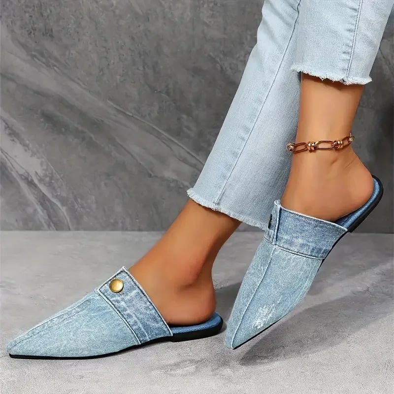 Close-up of gold-tone button accent on Sofia denim mule flat in blue