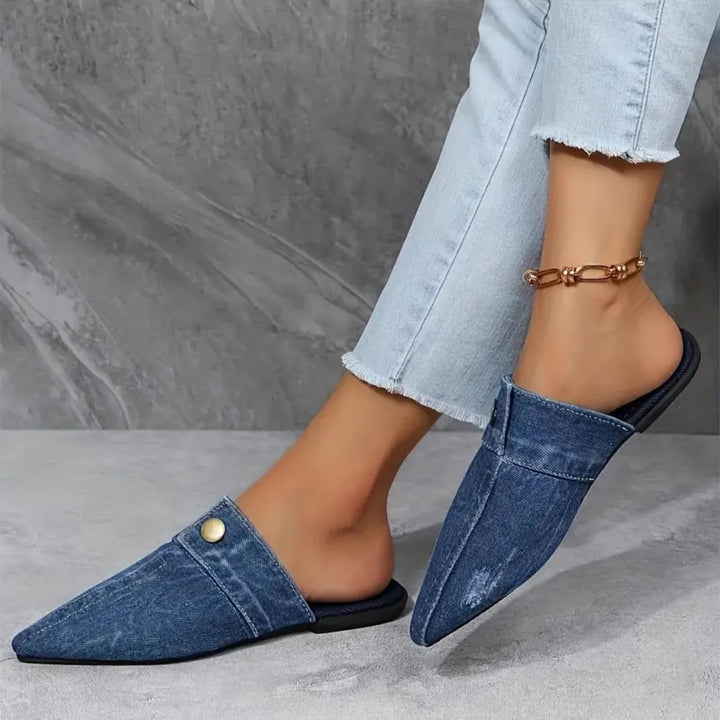 Model wearing Sofia denim mule flats in blue paired with straight-leg jeans, lifestyle shot