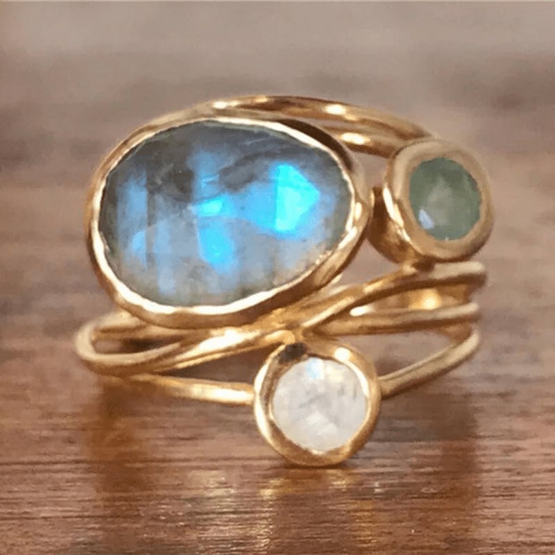 Close-up of a sparkling crystal gold ring with warm gold-tone finish, shown on a clean background