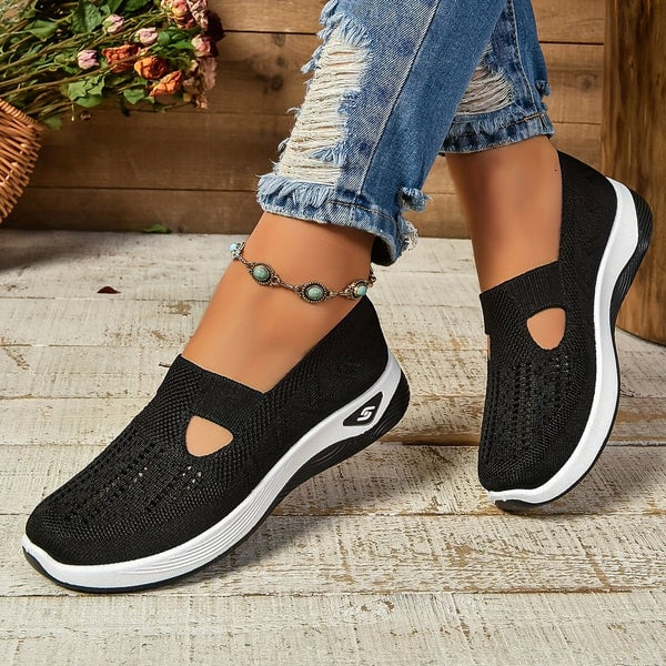 Soleil slip-on shoes in black colorway shown from the side on a white background