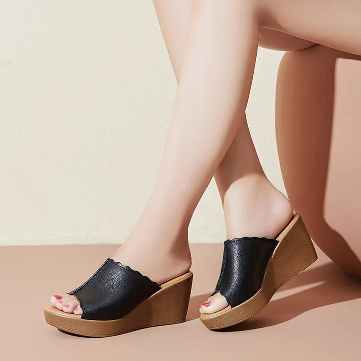 Soleil wedge sandals in black showing cushioned insole and secure ankle strap detail