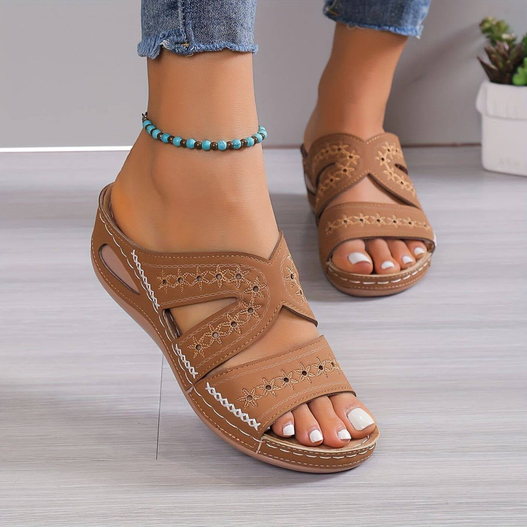 Brown orthopedic sandals laid flat showing full sole construction and strap detail
