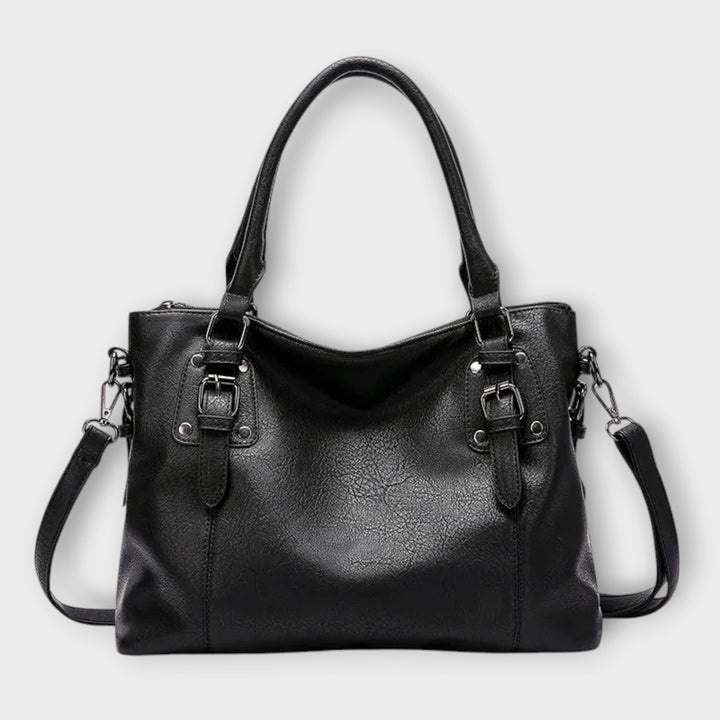 Side profile view of the Solveig structured handbag showing its spacious silhouette